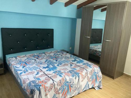 a bedroom with a bed and a dresser and a mirror at Residence l oiseau des iles in Grand-Bourg