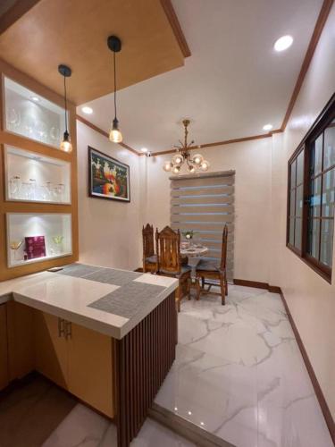a kitchen with a table and a dining room at Spacious Seaview Studio in Lila, Bohol in Lila