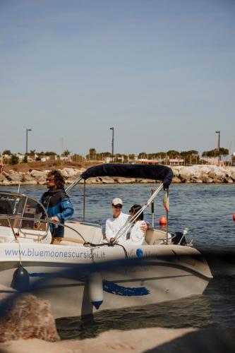 a group of people in a boat in the water at Le 3 di Tuccino in Polignano a Mare