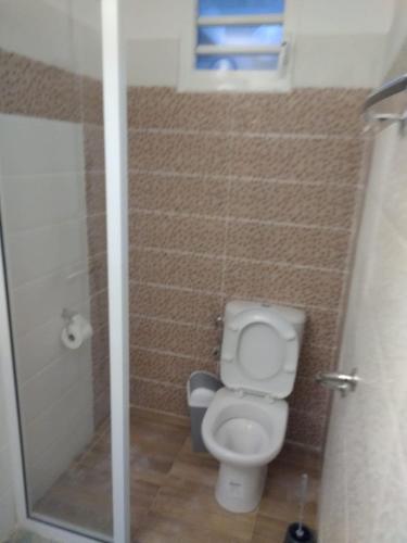 a small bathroom with a toilet and a shower at Residence l oiseau des iles in Grand-Bourg