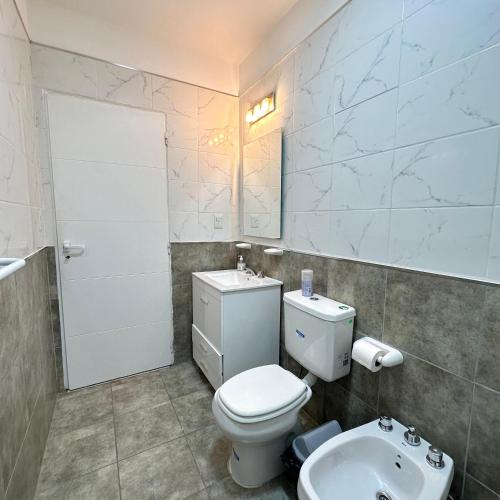 a bathroom with a toilet and a sink at Femiba in El Calafate