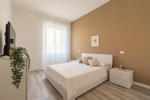 a bedroom with a white bed and a window at Rhome to Colosseum in Rome