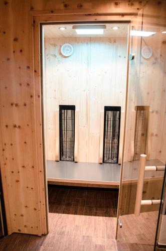 a room with wooden walls and a glass door at Ferienwohnungen Haid in Schönau am Königssee