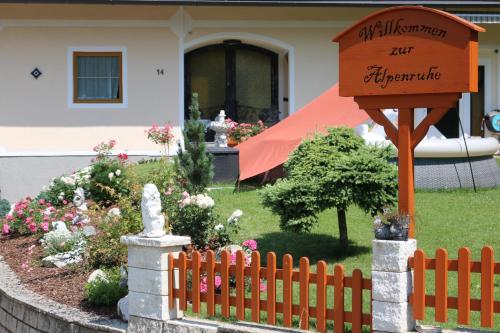 a fence with a sign in front of a house at Zur Alpenruhe in Seeboden