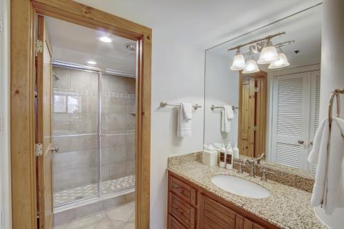 a bathroom with a shower and a sink and a mirror at Silver King by All Seasons Resort Lodging in Park City
