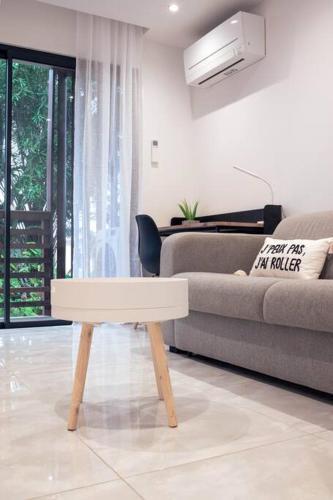 a living room with a couch and a table at BarraZen-Lofts-2-Netflix in Cayenne