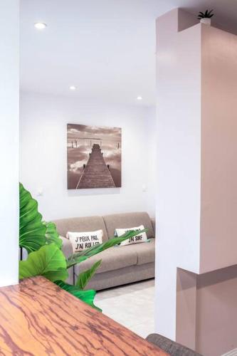 a living room with a couch and a table at BarraZen-Lofts-2-Netflix in Cayenne