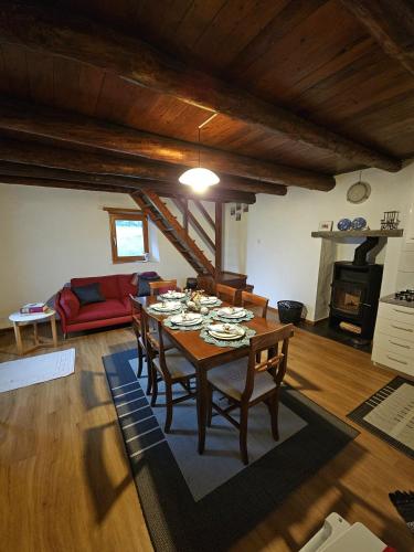 a living room with a table with chairs and a couch at Rustico Corte in Brissago