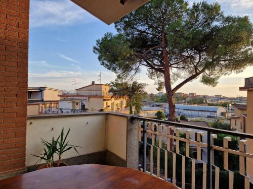 a balcony with a table and a tree at Roma Centro Apartment Tor Vergata in Tor Vergata