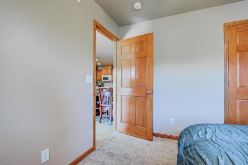 a bedroom with a door leading to a kitchen at Family-Friendly Unit 8 Mi to Appleton Downtown! in Appleton