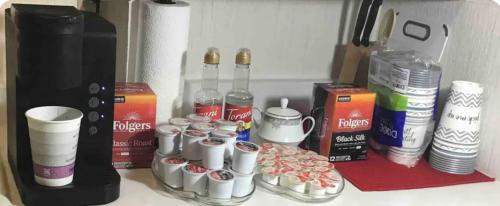 a counter top with a coffee maker and cups on it at Charming Carmel Suite 8 min to Carmel Arts District in Carmel