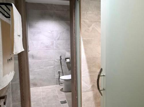 a bathroom with a toilet and a shower stall at Sunset Hotel for Hotel Services in Najran