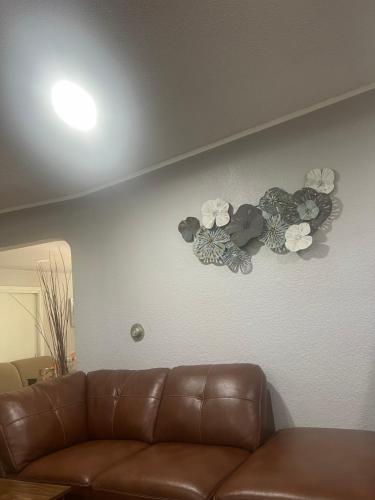 a living room with a couch and flowers on the wall at gravelly lake # 1 in Lakewood