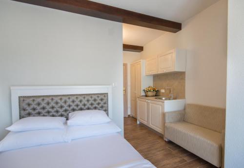 a bedroom with a white bed and a sink at Apartments Marija in Risan
