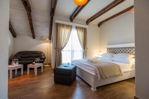 a bedroom with a bed and a chair and a window at Apartments Marija in Risan