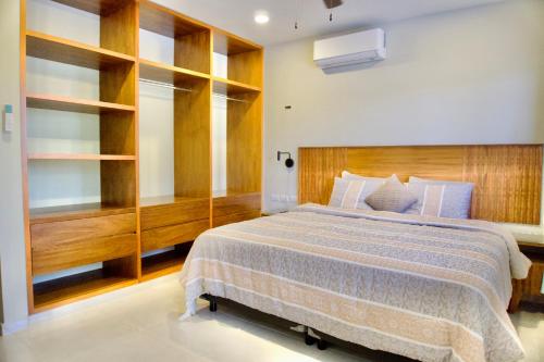 a bedroom with a large bed with a wooden headboard at Casa pavo real 350 MBS in Mérida