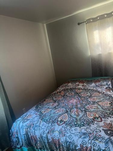 a bedroom with a bed with a colorful bedspread at gravelly lake # 1 in Lakewood