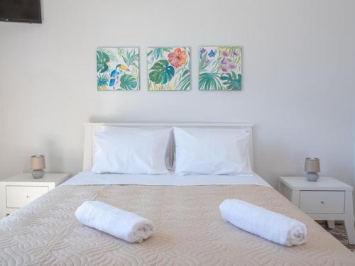 a bedroom with a bed with two pillows on it at Heraklions Heart Apartment in Heraklio Town