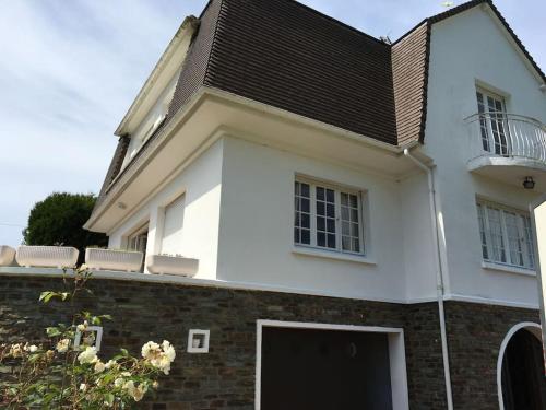 a white house with a black roof at Maison de charme - porte de Fécamp in Saint-Léonard