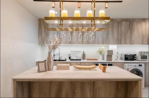 a kitchen with a large island in the middle at FM Ratchada in Ban Na Song