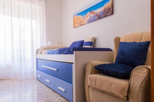 a bedroom with two beds and a chair at Balcón de la tejera in Cazorla