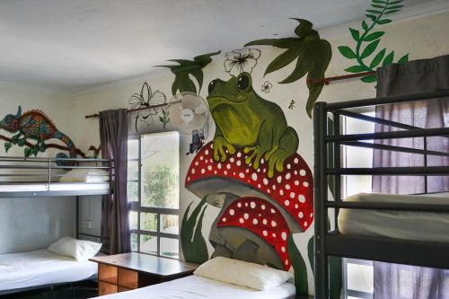 a room with a painting of a frog sitting on a mushroom at La Casa Verde in Murcia