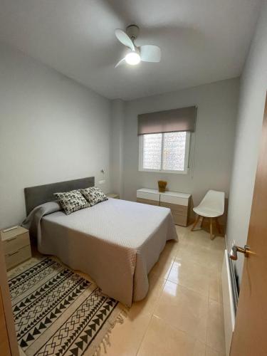 a bedroom with a bed and a ceiling fan at Nazareno in Villanueva de la Serena