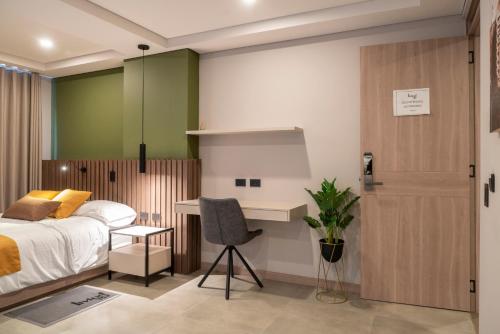a bedroom with a bed and a desk at Hotel Living 35 Suites in Medellín