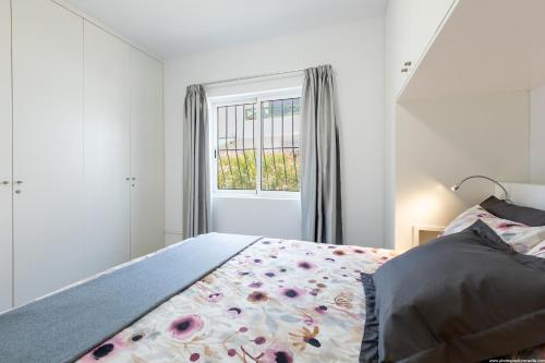 a bedroom with a bed and a window at Amantes del Mar, Heated pool in Costa Del Silencio