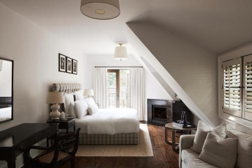 a bedroom with a bed and a table and a couch at Bedford Post Inn in Bedford