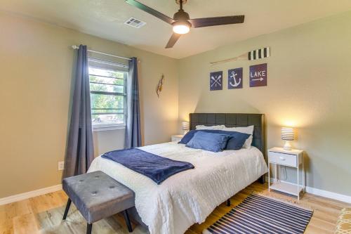 a bedroom with a bed with blue pillows and a window at On-Site Lake Access Pet-Friendly Vinita Home in Disney
