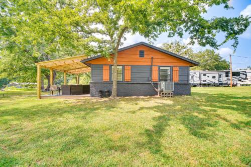 a small house in a yard with a tree at On-Site Lake Access Pet-Friendly Vinita Home in Disney