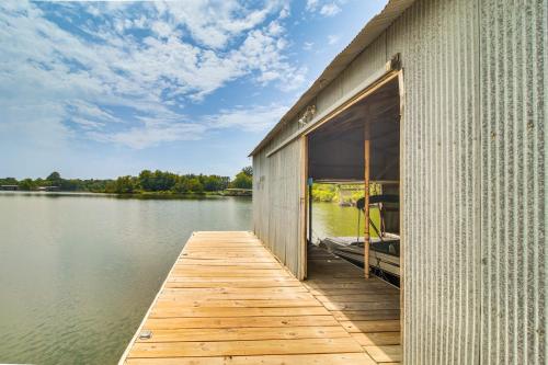 a building with a dock on a body of water at On-Site Lake Access Pet-Friendly Vinita Home in Disney