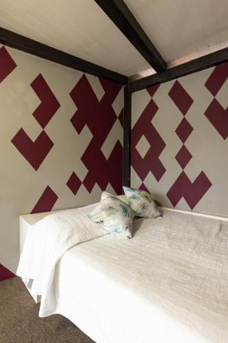 a bed with two pillows on it in a room at Satya Suites & Portal San Angel Flats in Mexico City