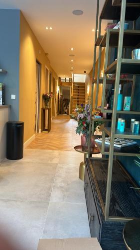 a hallway of a building with a room with flowers at The LIF Boutique in Amsterdam