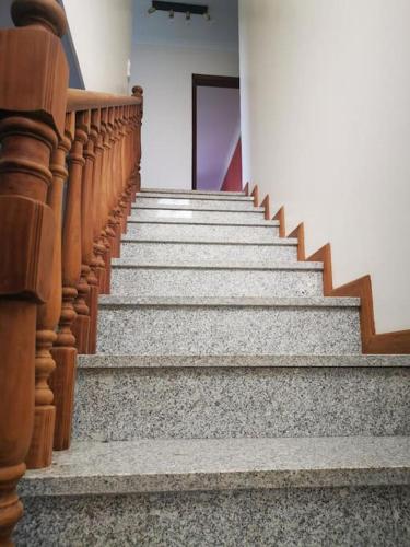 a set of wooden stairs in a building at Casa Das Origens, vue sur la vallée du Douro in Mesão Frio