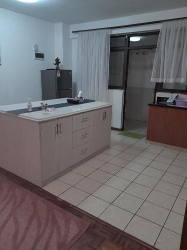 a large kitchen with a sink and a door to a garage at Faharihill place in Nairobi