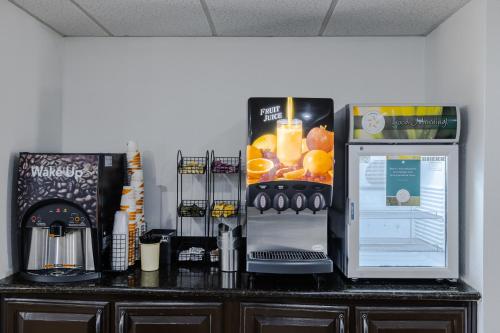 a counter top with a refrigerator on top of it at Quality Inn Olive Branch in Olive Branch