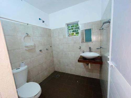 a bathroom with a toilet and a sink at Casa Laura in Puerto Escondido