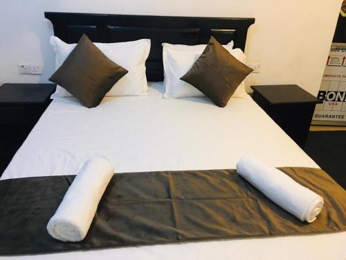 a large bed with two pillows and a blanket on it at Bracedale Estate in Kegalle