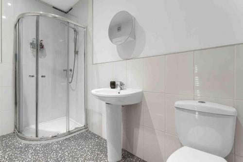 a bathroom with a shower and a toilet and a sink at Seagate Heights Large, Stylish, City Centre Flat in Dundee