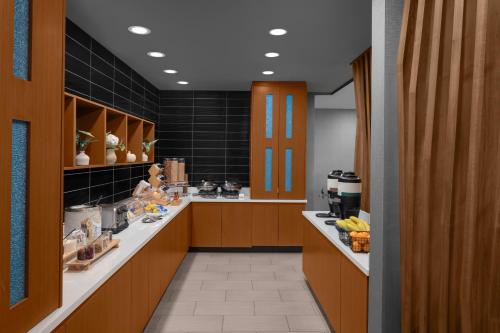 a large kitchen with brown cabinets and a counter at SpringHill Suites by Marriott Grand Rapids Airport Southeast in Cascade