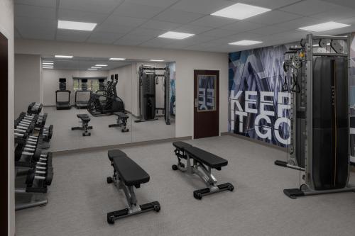 a gym with several treadmills and machines in a room at SpringHill Suites by Marriott Grand Rapids Airport Southeast in Cascade