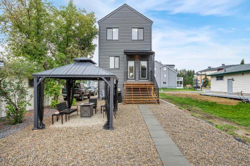 a home with a gazebo and a house at The Promenade I Patio and BBQ I Fire pit I Sleep 9 in Sylvan Lake