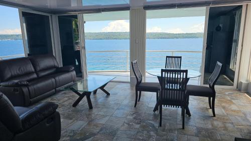 a living room with a couch and a table and chairs at Lydia's House in Kaputian