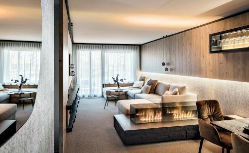 a living room with a couch and a fireplace at Tinzenblick in Davos