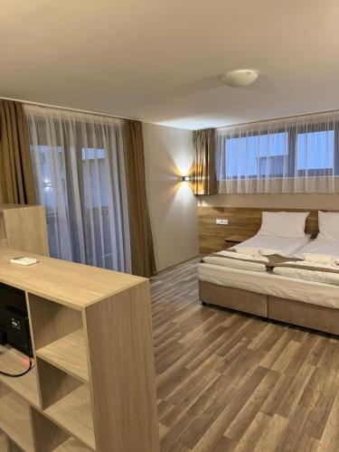 a bedroom with a bed and a desk in it at Къща Александра 2 in Dobrinishte