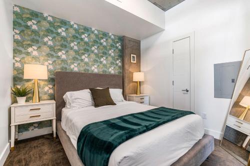 a bedroom with a large bed with a green blanket at Downtown beauty-PoolHotTubGym-near SaltPalace-View in Salt Lake City