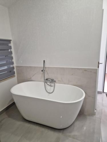a white bath tub sitting in a bathroom at Escapada Magica in São Martinho do Porto