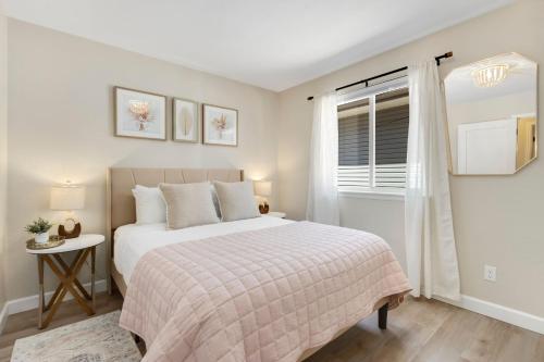 a bedroom with a bed and a window at Downtown Windsor Home with Hot Tub and Pool Table in Windsor